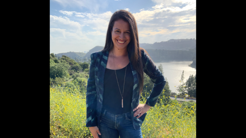 Picture of Jessica Gusik outdoors with a lake behind her. Jessica is the host of The Art of Speaking Up podcast and career coach She talks about the art of networking