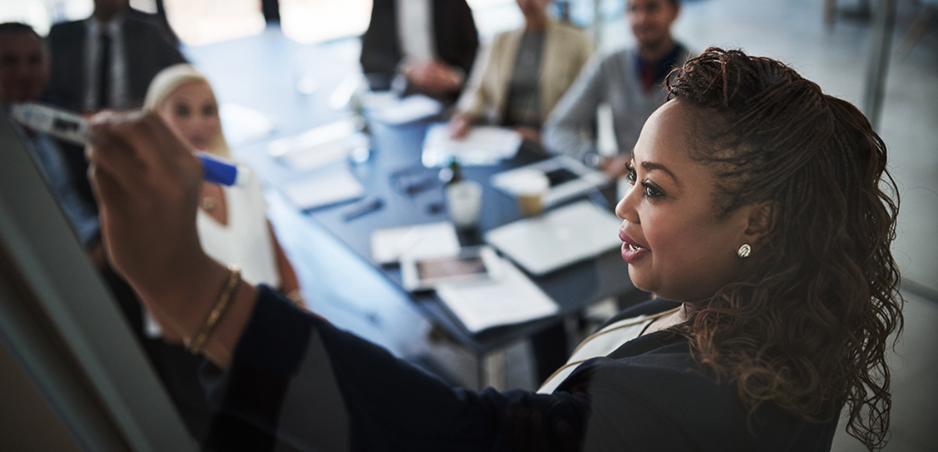 Black woman leading meeting with coworkers How To Craft Your Objectives: The Do's and Don'ts