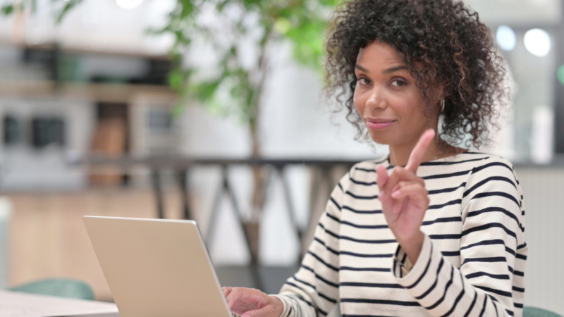 Black woman at desk in front of laptop setting workplace boundaries