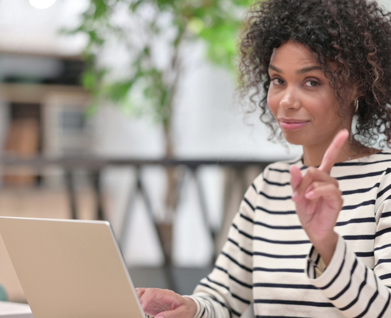 Black woman at desk in front of laptop setting workplace boundaries