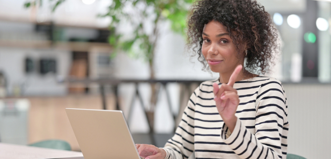 Black woman at desk in front of laptop setting workplace boundaries