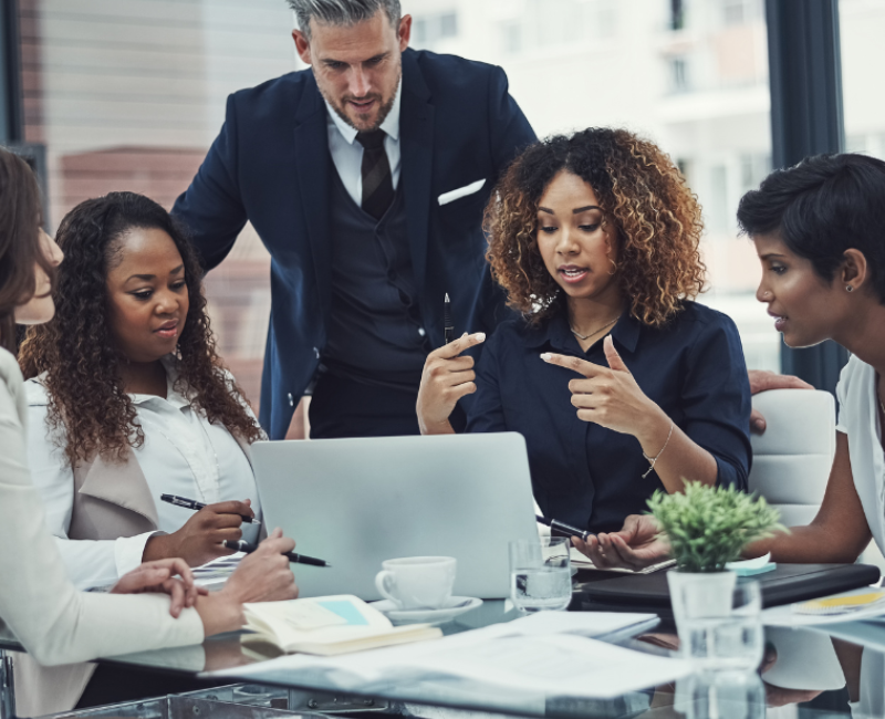 Black woman using impactful communication to lead a meeting in an office