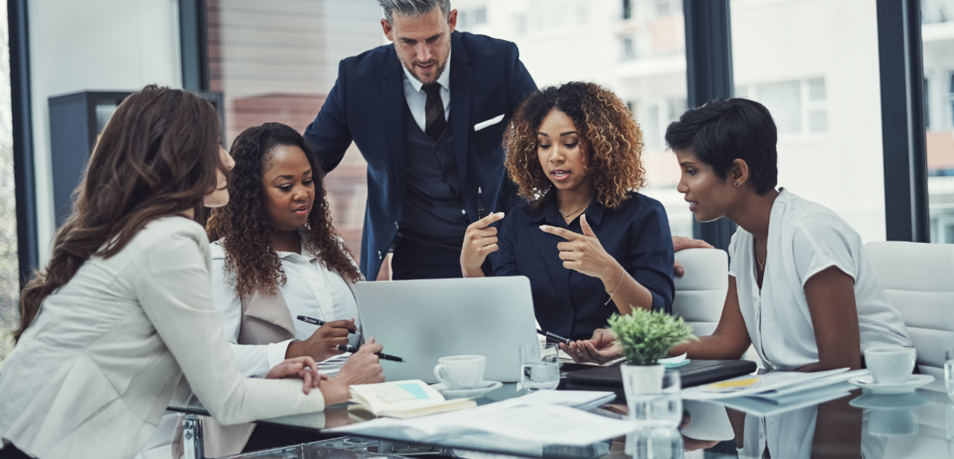 Black woman using impactful communication to lead a meeting in an office