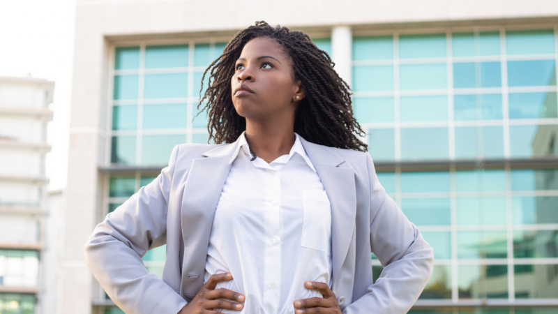 Confident young businesswoman with hands on waist How to build a powerful personal brand that opens doors